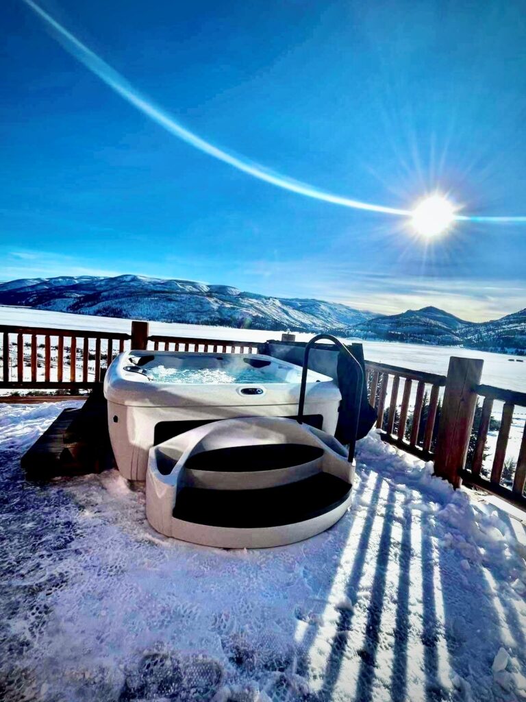 hot tub in the sunshine and snowy mountains
