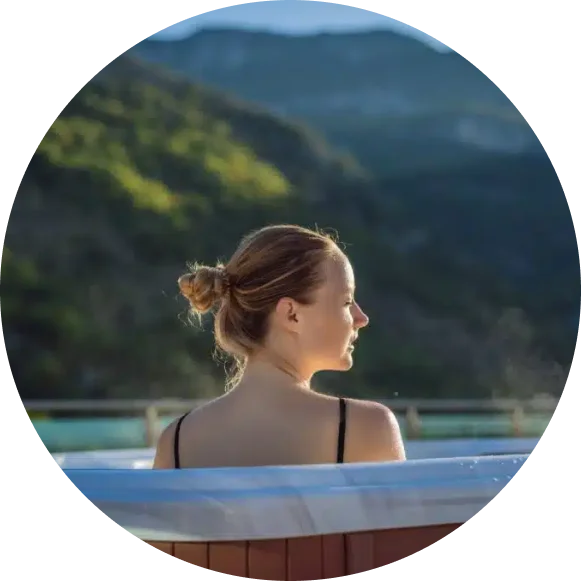 lady in outdoor spa with scenery in the background